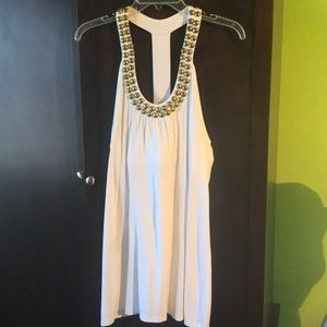 Adorable long white tank top with brass gems.